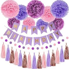 a happy birthday banner with tissue flowers and tassels