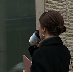 a woman with a coffee cup in her hand