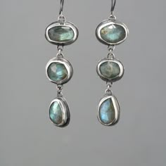 These eye catching dangle earrings feature a row of three natural rose cut labradorite stones. They are a lovely soft grey with fascinating flashes of green and blue. They are lovingly set in handmade sterling silver bezel settings with sterling french ear wire. The silver has an oxidized finish Labradorite Earrings, Dope Jewelry, Funky Jewelry, Jewelry Lookbook, Gem Stones, Stone Work, Jewelry Inspo, Dream Jewelry, Pretty Jewellery