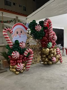 an outdoor christmas decoration with santa and candy canes