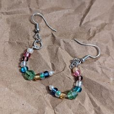 Cute, colorful beaded crescent moon earrings. They hang so you can see the moon shape! Casual Colorful Beaded Earrings As Gift, Casual Colorful Beaded Earrings For Gift, Casual Dangle Earrings With Colorful Beads, Casual Multicolor Dangle Beaded Earrings, Casual Multicolor Beaded Dangle Earrings, Multicolor Round Beads Crystal Earrings For Pierced Ears, Crescent Moon Beaded Earrings, Multicolor Crystal Earrings With Round Beads, Multicolor Round Beaded Crystal Earrings