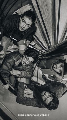 black and white photograph of four people standing together