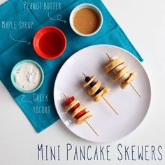 mini pancake skewers on a plate with dipping sauces