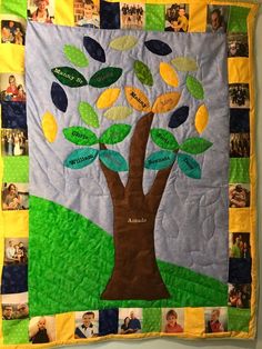 a family tree quilt hanging on the wall with many pictures and words attached to it