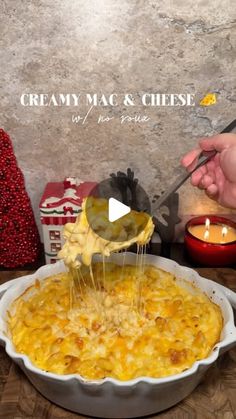 a person is sprinkling cheese onto a casserole in a white dish