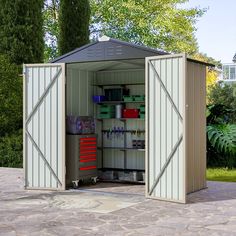 an outdoor storage shed with its doors open