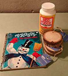 a book and some food sitting on a table next to a jar of marmalade