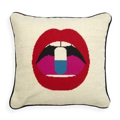 a cross stitch pillow with the shape of a kiss on it's lips in red, white and blue