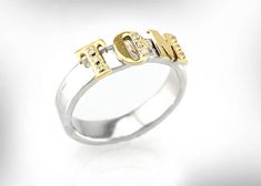 a white and yellow gold ring with the word love written in two letters on it