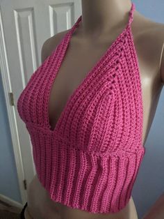 a mannequin wearing a pink knitted top