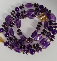 Handmade jewelry set of natural Amethyst.  Necklace made of different shape Amethyst beads with gold Hematite accents. Length 60cm. Toggle. Layered bracelet of natural Amethyst. Magnetic clasp. For16-16.5cm wrist. Suitable for air signs of the zodiac, especially Aquarius and Aries.  The set comes in a gift box ready for gifting. You might also like https://www.etsy.com/uk/shop/LoveIuliia?ref=seller-platform-mcnav§ion_id=38541683 https://www.etsy.com/uk/shop/LoveIuliia?ref=l2-about-shopname§ion_i Gemstone Rondelle Jewelry Gift, Spiritual Single Strand Amethyst Jewelry, Rondelle Crystal Necklaces With Natural Stones For Gifts, Amethyst Gemstone Necklaces With Round Beads, Faceted Amethyst Purple Jewelry, Gold Amethyst Single Strand Necklace, Purple Faceted Amethyst Jewelry, Faceted Purple Amethyst Jewelry, Amethyst Necklace With Natural Stones As Gift