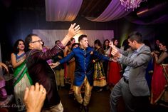 a group of people standing around each other on a dance floor