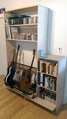 a book shelf with guitars and books in it