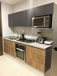 a kitchen with stainless steel appliances and wooden cabinets