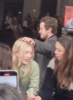 the man is cutting the woman's hair at the event