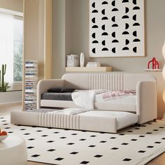 a white couch sitting on top of a rug in a living room