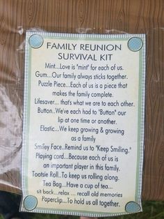 a family reunion survival kit is hanging on a wooden fence in front of some grass