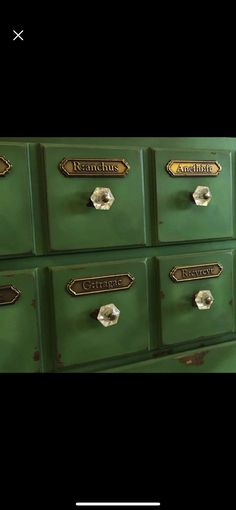 an old green dresser with brass knobs on it's drawers and the words antique written in gold