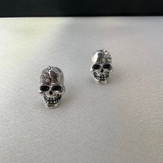 Elevate your streetwear game with these edgy Skull Head Stud Earrings. Perfect for both men and women, these punk-inspired earrings exude hip hop and unisex style. Add a daring touch to any outfit and make a bold statement with these unique earrings. Earrings length 0.6 inch width 0.3 inch. Silver Emo Earrings For Parties, Alternative Style Silver Party Earrings, Silver Punk Plug Earrings For Parties, Edgy Silver Earrings For Alternative Fashion, Gothic Metal Earrings For Streetwear, Edgy Earrings For Concert, Trendy Silver Skull Jewelry, Punk Metal Earrings For Concerts, Punk Style Metal Plug Earrings For Parties