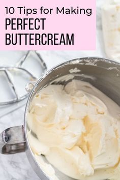 a metal bowl filled with whipped cream on top of a counter