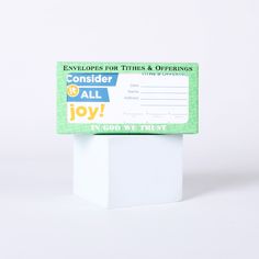 an envelope for this and offerings to all the joy in god we trust on white background