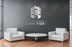 two chairs and a table in front of a wall with the law firm logo on it