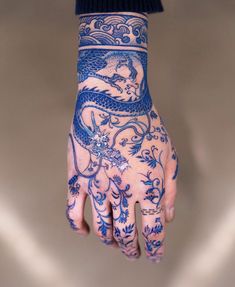 a person's hand with tattoos on it