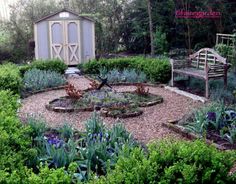 a garden with lots of plants and a bench in front of the shed that is built into the ground