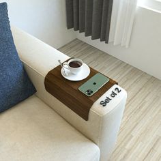 a couch with a cup of coffee on top of it