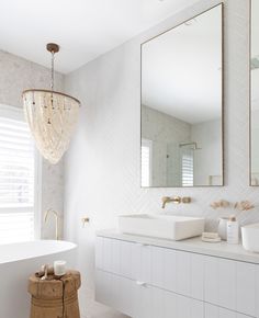 a bathroom with two sinks and a large mirror on the wall next to a bathtub