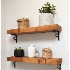 two wooden shelves with plants and vases on them