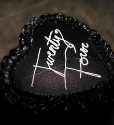 a black cake with white writing on it