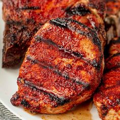 grilled meat on a plate with sauce and seasoning sprinkled around it