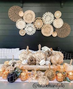 pumpkins and gourds are arranged on a table