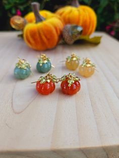 These cute carved pumpkin earrings come in a variety of colors including orange, blue, and yellow. Accented with peridot to represent the leaves and hooked onto surgical steel ear wires.  Choose from either gold or silver! Please note each pair will be a unique color due to natural stone variations.  Packaged in a jewelry box and shipped in an eco friendly mailer. Stone Pumpkin, Pumpkin Jewelry, Autumn Earrings, Orange Jewelry, Carved Pumpkin, Blue Pumpkins, Pumpkin Earrings, Carved Stone, Fall Earrings