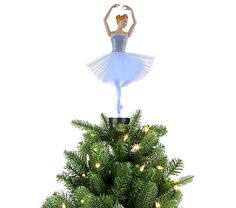 a christmas tree with a ballerina on top and lights in the shape of a star