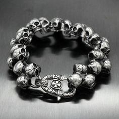 Men's Thick Heavy Punk Multi Skulls Biker 316L Stainless Steel Chain Bracelet Silver Skull Print Bracelets As A Gift, Gothic Stainless Steel Skull Bracelets, Edgy Metal Skull Bracelets, Edgy Skull Metal Bracelets, Edgy Skull-shaped Metal Bracelets, Punk Silver Skull Bracelets, Silver Skull Bracelets In Punk Style, Punk Stainless Steel Bracelets For Streetwear, Silver Punk Bracelet For Biker Events