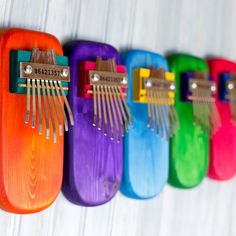 a row of colorful combs hanging on a wall