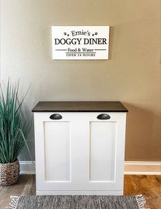 the dogy diner sign is above two white cupboards and a rug on the floor