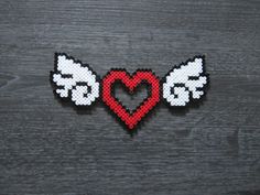 the pixel heart with wings is shown in red, white and blue on a black background