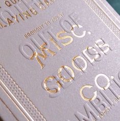 a close up view of some type of business card with gold foil on the front