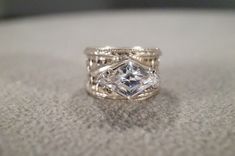 I am offering you this vintage sterling silver (stamped ) wedding band stacker design ring. It features a bold marquise shaped prong  set genuine white topaz stone, set in an east to west fashion.  Truly a most spectacular detailed Art Deco  style ring. It features a detailed etched inter woven design setting. It is currently a size 6.5,  though I am sure this could easily be sized up or down. It measures app. 3/4 inch, by  app.   1/2  inch and it weighs app. 7  grams. This is a must have to add Silver Solitaire Marquise Wedding Ring, Silver Stackable Marquise Rings, Vintage Silver Marquise-shaped Jewelry, Vintage Marquise Silver Jewelry, Vintage Silver Marquise Jewelry, Diamond-shaped Silver Jewelry For Weddings, Silver Diamond-shaped Jewelry For Weddings, Unique Silver Marquise Cut Rings, Unique Silver Marquise Jewelry