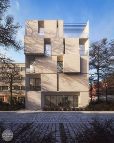 the building has many windows and is made out of concrete blocks, which are stacked on top of each other