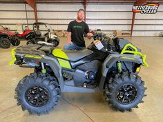 a man sitting on an atv in a garage