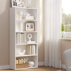 a white book shelf with books and pictures on it