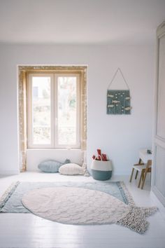 a white room with a large rug on the floor