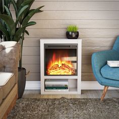 a living room with a blue chair and a fire place in the corner next to a plant