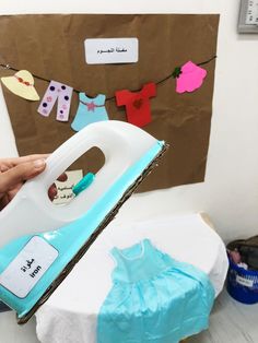 a person is ironing clothes on a sheet of paper with a steam iron in front of them