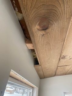 the inside of a house that is being remodeled with wood planks on the ceiling