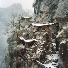 a mountain side house with snow on the ground